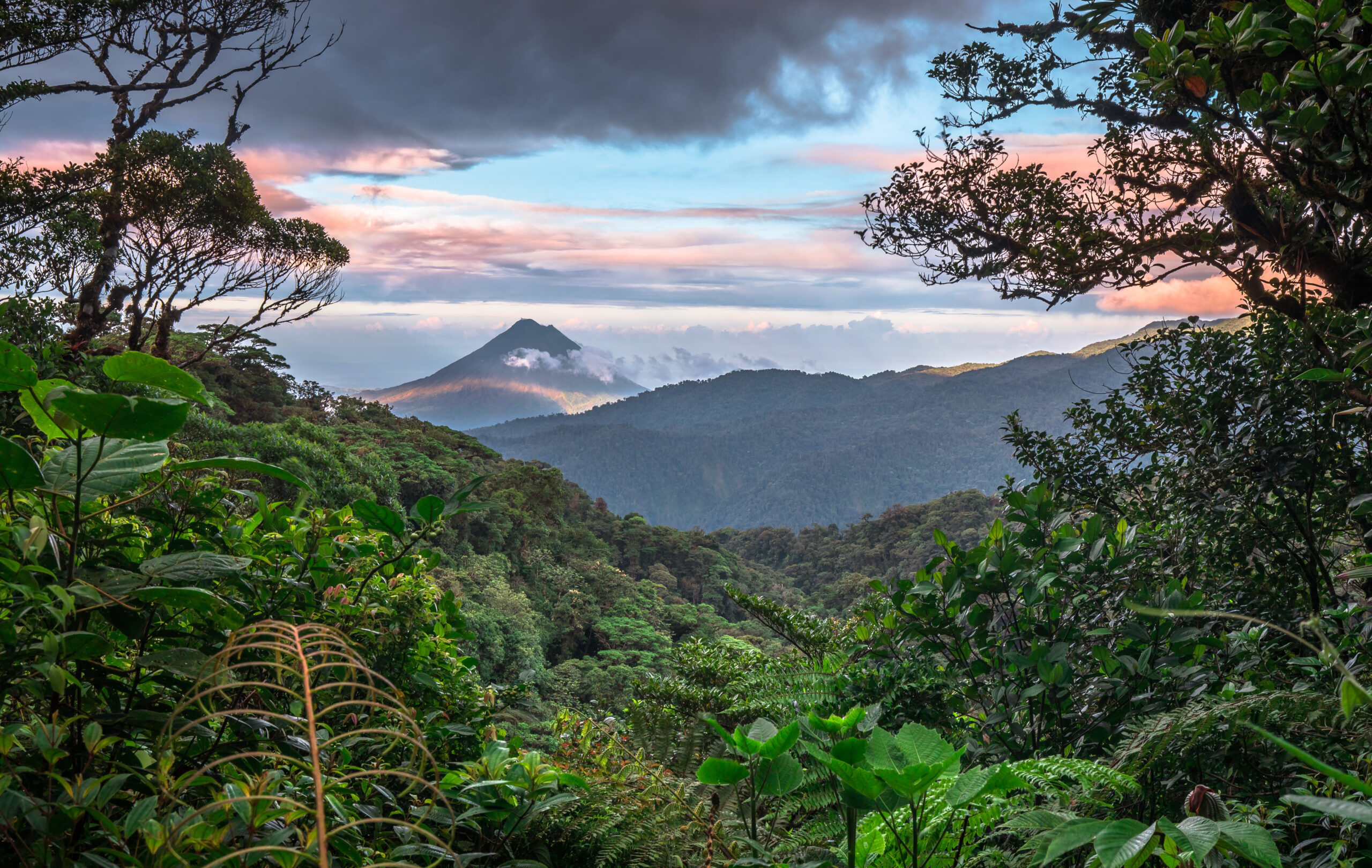 Volcan Arenal dominates the landscape during sunset, as seen fro